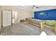 Finished basement area featuring a futon, TV, neutral carpet and a cozy layout at 10218 Garden Alcove Dr, Tampa, FL 33647