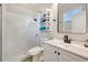 Modern bathroom featuring a white vanity, updated fixtures, and stand up shower with white marble look tile at 10218 Garden Alcove Dr, Tampa, FL 33647