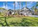Beautiful two-story home with well-manicured lawn, mature trees, and vibrant landscaping, enhancing curb appeal at 10218 Garden Alcove Dr, Tampa, FL 33647