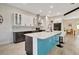 Kitchen featuring white and dark cabinets, stainless steel appliances, and a quartz countertop island with bar seating at 10218 Garden Alcove Dr, Tampa, FL 33647