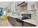 The modern kitchen features stainless steel appliances, granite countertops, and a decorative tile backsplash at 10218 Garden Alcove Dr, Tampa, FL 33647