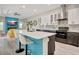 Modern kitchen boasts a center island with bar seating, sleek cabinetry, and a stylish backsplash at 10218 Garden Alcove Dr, Tampa, FL 33647