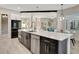 Modern kitchen with a large island, stainless steel appliances, and a view to a cozy living area at 10218 Garden Alcove Dr, Tampa, FL 33647