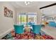 Bright living room with a vibrant rug, comfortable seating, and sliding doors to the pool area at 10218 Garden Alcove Dr, Tampa, FL 33647