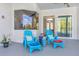 Inviting covered patio with comfortable seating and view of the interior through expansive glass doors and large picture window at 10218 Garden Alcove Dr, Tampa, FL 33647