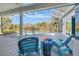 Screened patio features comfortable seating and scenic views of the backyard and pool at 10218 Garden Alcove Dr, Tampa, FL 33647