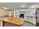 Functional kitchen featuring bright cabinetry and a kitchen island for extra space at 1051 Hawthorn St, Zephyrhills, FL 33540