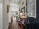 Warm entryway featuring wood floors, an archway, and stylish decor leading into the living space at 1091 Old Windsor Way, Spring Hill, FL 34609