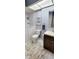 Bright bathroom with walk-in tub, modern vanity, and tiled flooring at 1102 Old Mill Pond Rd, Palm Harbor, FL 34683
