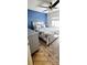 Bedroom with a large window and a bed featuring blue and white patterned quilt at 1102 Old Mill Pond Rd, Palm Harbor, FL 34683