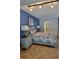Stylish bedroom featuring a blue accent wall, comfortable furnishings, and a modern aesthetic at 1102 Old Mill Pond Rd, Palm Harbor, FL 34683