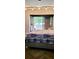 Cozy bedroom with a sliding glass door and neutral tones at 1102 Old Mill Pond Rd, Palm Harbor, FL 34683