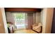 Bedroom featuring a chair, sliding glass doors, and lots of natural light at 1102 Old Mill Pond Rd, Palm Harbor, FL 34683