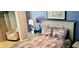 Well-lit bedroom showcasing blue walls, a comfortable bed, and stylish furnishings at 1102 Old Mill Pond Rd, Palm Harbor, FL 34683