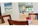 Open dining area with mirrored bar and marble table at 1102 Old Mill Pond Rd, Palm Harbor, FL 34683