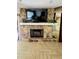 Stone fireplace with a mounted TV, providing a cozy focal point in the living room at 1102 Old Mill Pond Rd, Palm Harbor, FL 34683