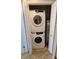 A stacked washer and dryer in a closet at 1102 Old Mill Pond Rd, Palm Harbor, FL 34683