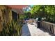 Inviting outdoor patio with stone tile, grill, and privacy hedge, perfect for entertaining guests at 1102 Old Mill Pond Rd, Palm Harbor, FL 34683