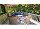 Cozy patio featuring comfortable wicker furniture and lush green surroundings for relaxing outdoor living at 1102 Old Mill Pond Rd, Palm Harbor, FL 34683