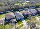 An aerial view of the houses in a neighborhood; this house features a screened-in pool and a well-manicured lawn at 11218 Creek Haven Dr, Riverview, FL 33569