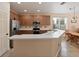 Well-lit kitchen with stainless appliances, wood cabinets, white countertops and tiled flooring at 11218 Creek Haven Dr, Riverview, FL 33569