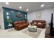 Beautifully decorated living room with leather sofas and an eye-catching accent wall at 1127 King Arthur Ct # 314, Dunedin, FL 34698