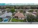An aerial view of the property showing the backyard, lanai, privacy fence, and mature trees at 1220 Emerald Hill Way, Valrico, FL 33594