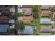 An aerial view shows a single Gathering home with backyard, lanai, and a white privacy fence at 1220 Emerald Hill Way, Valrico, FL 33594