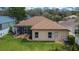 An aerial view shows the backyard, lanai, manicured lawn, shrubs, and privacy fence at 1220 Emerald Hill Way, Valrico, FL 33594