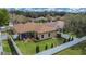An aerial view of the property showing the backyard, mature trees, and white privacy fence at 1220 Emerald Hill Way, Valrico, FL 33594