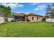 Spacious backyard showing the privacy fence, lush lawn, patio and screened-in patio at 1220 Emerald Hill Way, Valrico, FL 33594