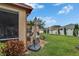 View of patio, grill and backyard showing a privacy fence and mature trees at 1220 Emerald Hill Way, Valrico, FL 33594