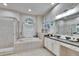 Bathroom with tub, shower, window, cabinets, and sink at 1220 Emerald Hill Way, Valrico, FL 33594