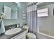 Bathroom features a vanity with backsplash and a tub/shower combination with curtain at 1220 Emerald Hill Way, Valrico, FL 33594