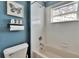 Bathroom features a tub/shower combination with decorative window at 1220 Emerald Hill Way, Valrico, FL 33594