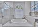 A bathtub under a window with window treatments at 1220 Emerald Hill Way, Valrico, FL 33594
