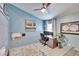 Bedroom features a ceiling fan, a desk area, and a decorative accent wall design at 1220 Emerald Hill Way, Valrico, FL 33594