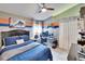 Bedroom features a large bed, an area for a desk, and a ceiling fan at 1220 Emerald Hill Way, Valrico, FL 33594