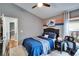 Bedroom features a bed, fan and an area for a desk near a window at 1220 Emerald Hill Way, Valrico, FL 33594