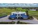 Exterior view of the community clubhouse with golf course in the background at 1220 Emerald Hill Way, Valrico, FL 33594