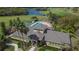 Community recreation center featuring a pool, basketball court, lush landscaping, and palm trees overlooking the golf course at 1220 Emerald Hill Way, Valrico, FL 33594