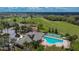 Aerial shot showcases the community center with lush green golf course views, pool, and full basketball court at 1220 Emerald Hill Way, Valrico, FL 33594