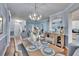 Open dining room with hardwood floors, stylish furnishings, and view to living area create an inviting space at 1220 Emerald Hill Way, Valrico, FL 33594