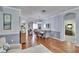 A cozy dining room features hardwood floors, a chandelier, and a mirror to add elegance to the room at 1220 Emerald Hill Way, Valrico, FL 33594