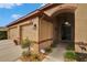 Inviting front entrance featuring a double garage, arched entryway and a well-maintained landscape at 1220 Emerald Hill Way, Valrico, FL 33594