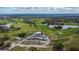 Expansive aerial view of a beautifully maintained golf course, lakes, and driving range at 1220 Emerald Hill Way, Valrico, FL 33594