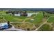 Aerial view of picturesque golf course with well-manicured greens, sand traps, and a serene lake at 1220 Emerald Hill Way, Valrico, FL 33594