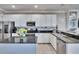 Kitchen with white cabinets, black countertops and stainless steel appliances at 1220 Emerald Hill Way, Valrico, FL 33594