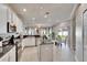 Bright, modern kitchen with stainless steel appliances, granite countertops and an island, offering a spacious and functional design at 1220 Emerald Hill Way, Valrico, FL 33594