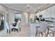 Kitchen with white cabinets and black countertops, in view of the table and slider at 1220 Emerald Hill Way, Valrico, FL 33594